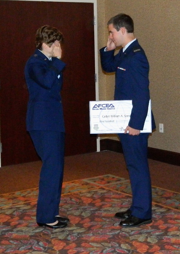 Gen. Wolfenbarger (l) presents a $500 Air Force ROTC scholarship to Cadet Sorenson in October.